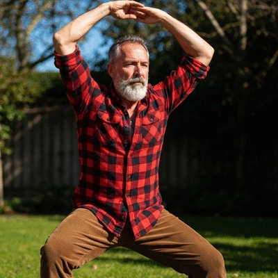Woman performing a weight-bearing exercise outdoors