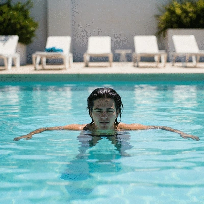 Person enjoying swimming in a serene pool