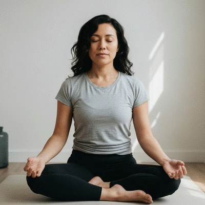 Person practicing mindful breathing in a serene environment, eyes closed, calm expression, soft lighting, no text, no words, no typography, no labels, clean image